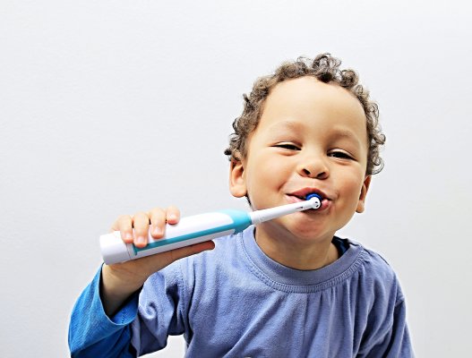 Electric toothbrush being used by a child 
